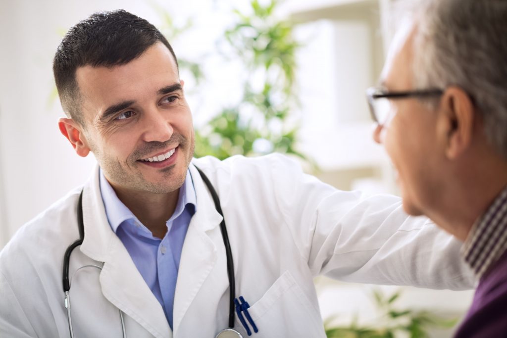 a physician is talking with a patient